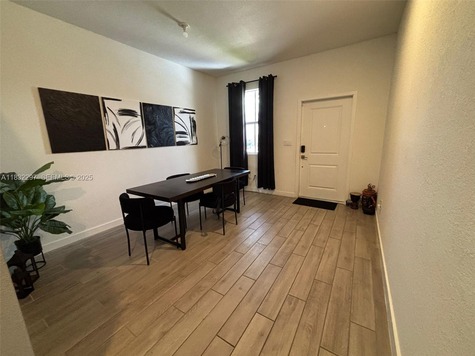 830 Southeast 19th Street Homestead, FL 33034 - Photo 16 of 16 a view of a livingroom with furniture and wooden floor