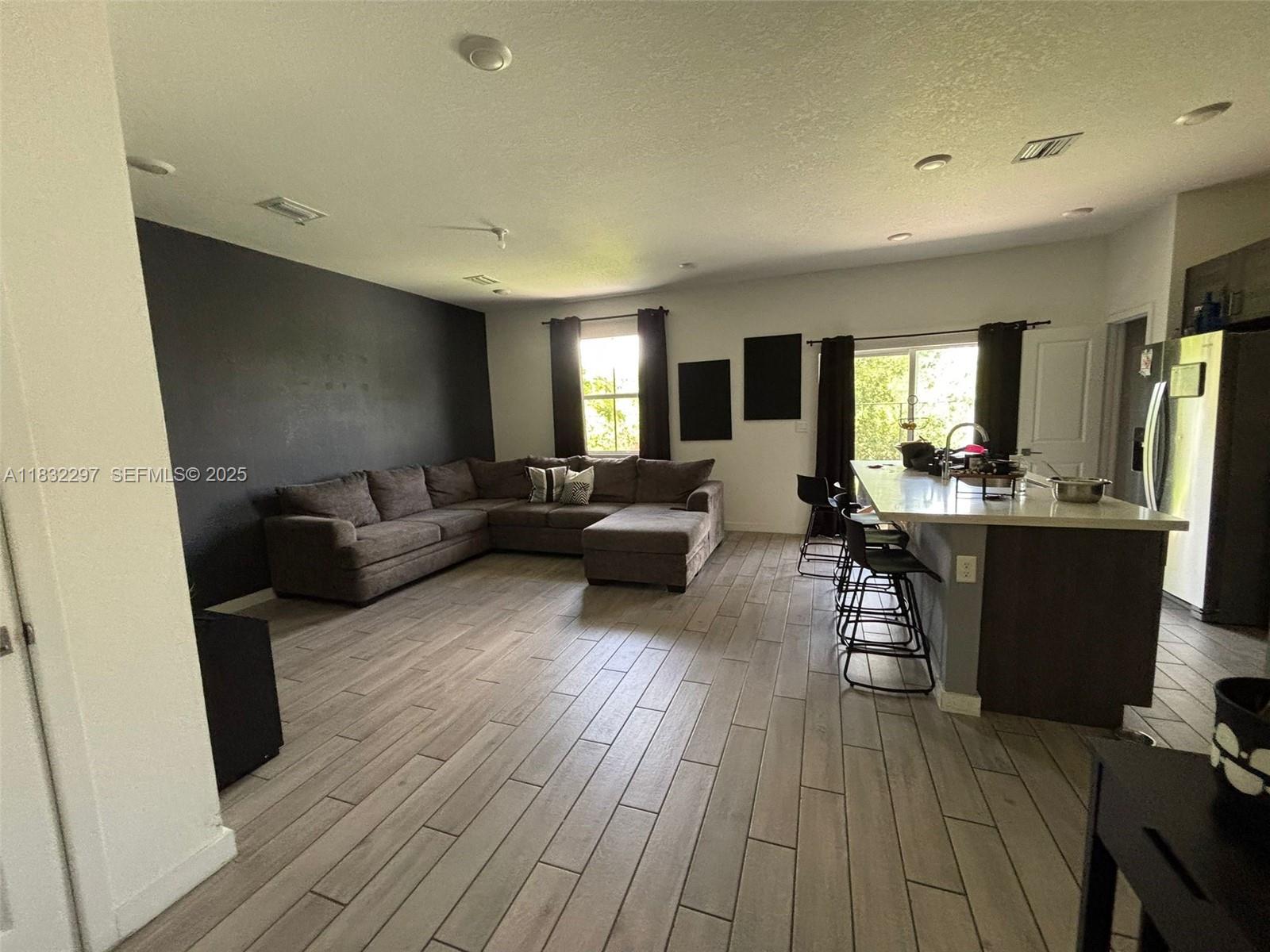 830 Southeast 19th Street Homestead, FL 33034 - Photo 2 of 16 a living room with furniture and a wooden floor