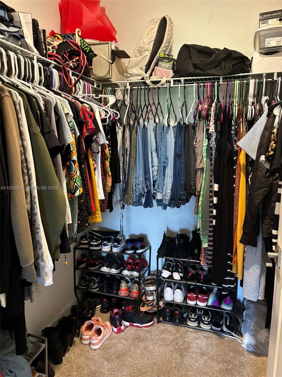830 Southeast 19th Street Homestead, FL 33034 - Photo 7 of 16 a view of walk in closet with clothes and shoes