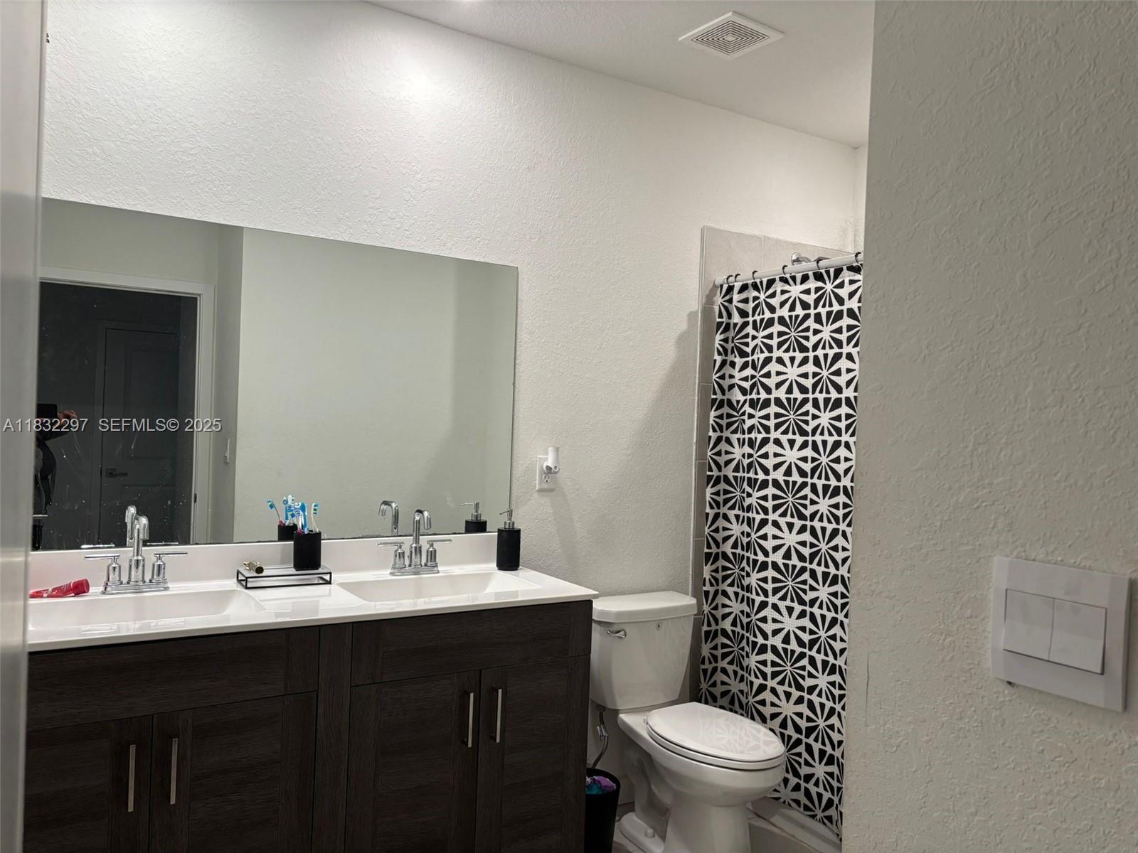 830 Southeast 19th Street Homestead, FL 33034 - Photo 8 of 16 a bathroom with a sink and a mirror