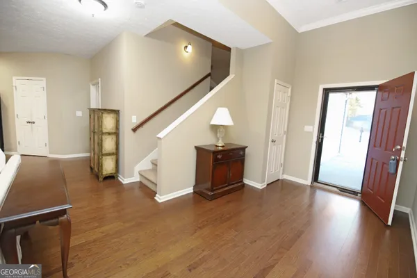 a view of an entryway with wooden floor