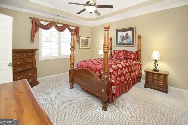 a bedroom with a bed and dresser with mirror