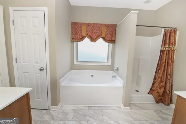 a bathroom with a white tub shower and vanity