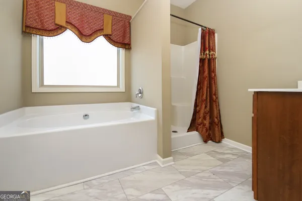 a bathroom with a bathtub and a shower