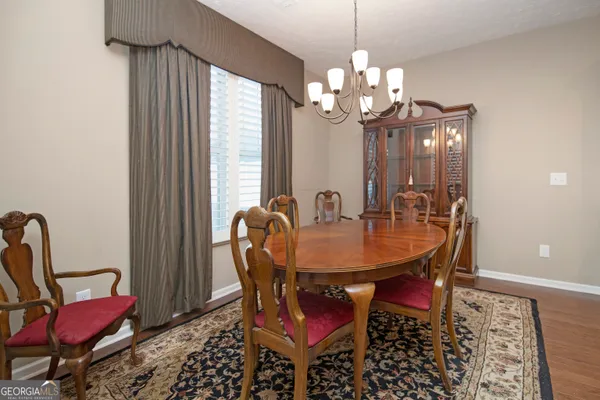 a view of a dining room with furniture and chandelier
