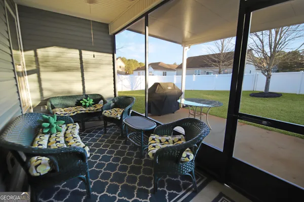 a living room with furniture and a floor to ceiling window