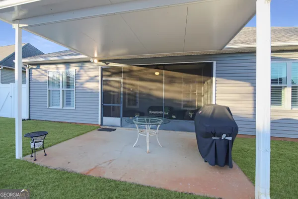 a house view with a garden space and seating space