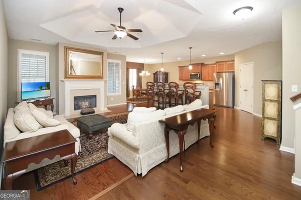 a living room with furniture fireplace and a chandelier