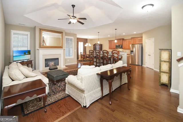 a living room with furniture fireplace and a chandelier