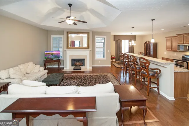 a living room with furniture a fireplace and a chandelier