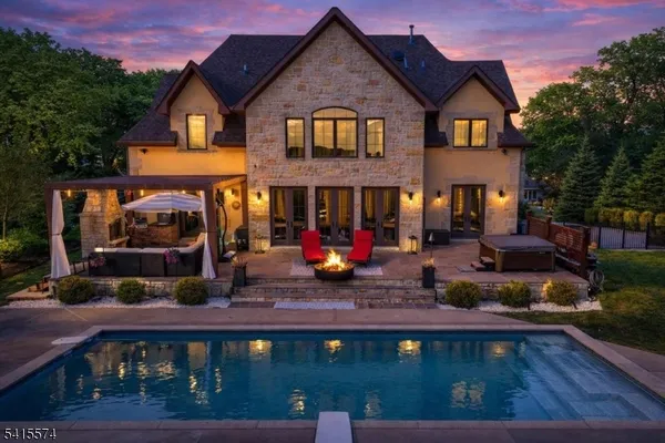 a view of a chairs and table in the back yard of a house
