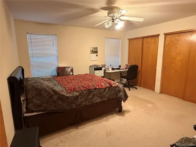 a bedroom with a bed and chair