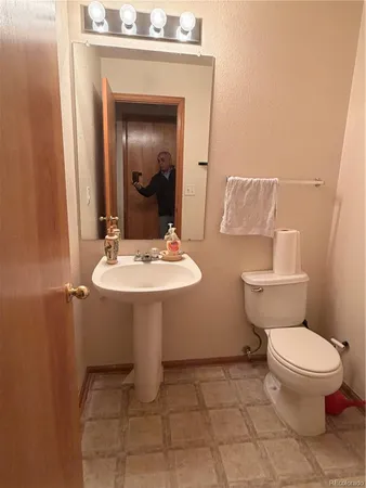 a bathroom with a sink toilet and mirror