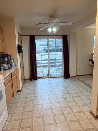 a view of a kitchen with a sink and a refrigerator