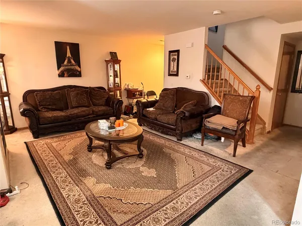 a living room with furniture and a rug