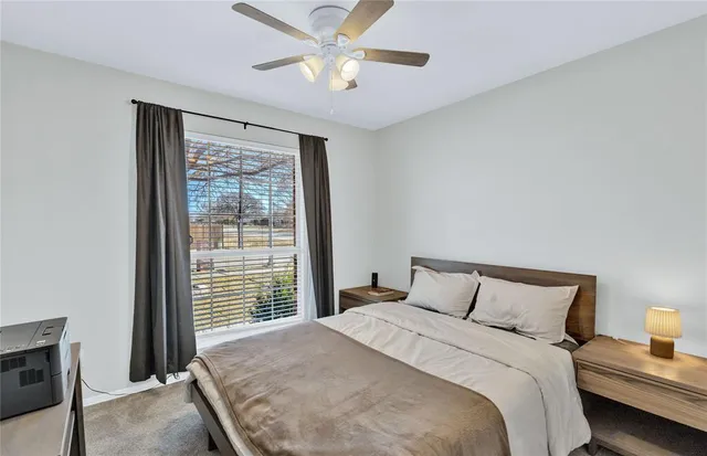 a bedroom with a large bed and a large window