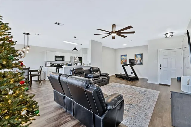 a living room with furniture and a potted plant