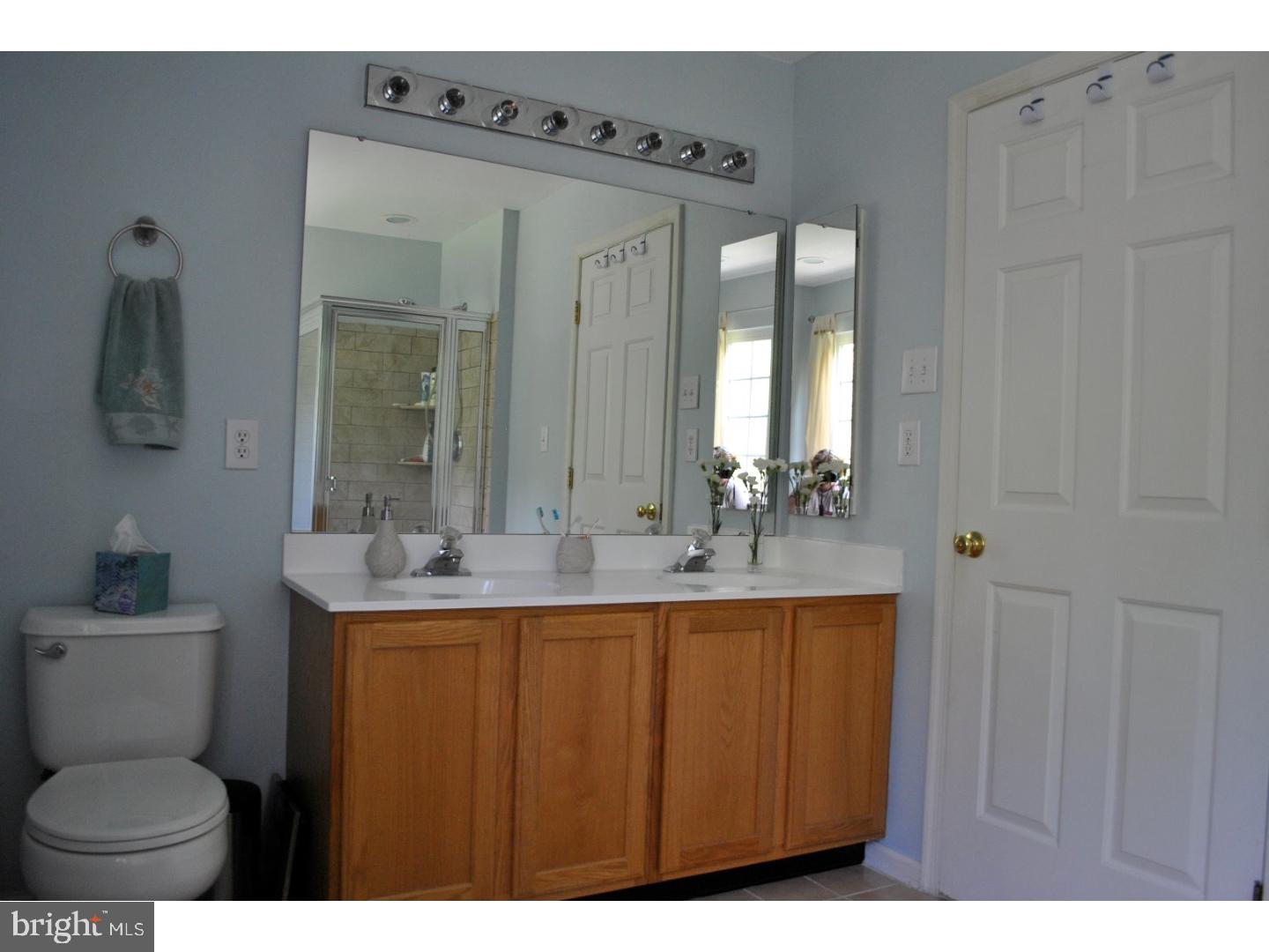 1854 Dixie Line Road Newark, DE 19702 - Photo 14 of 24 a bathroom with a toilet a sink and mirror
