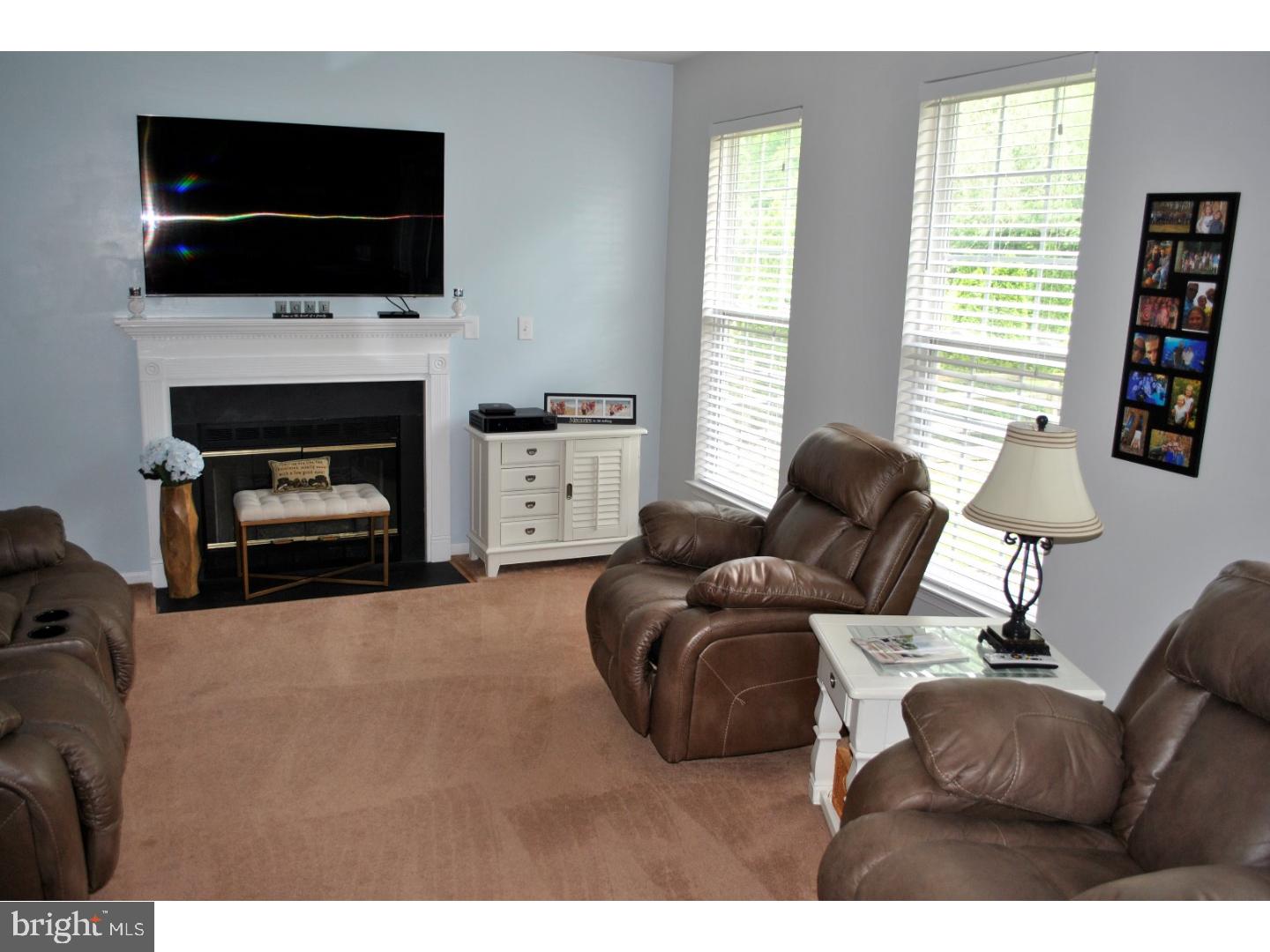 1854 Dixie Line Road Newark, DE 19702 - Photo 5 of 24 a living room with furniture a flat screen tv and a fireplace