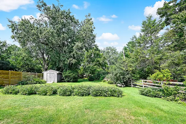a view of a garden with a house in the background