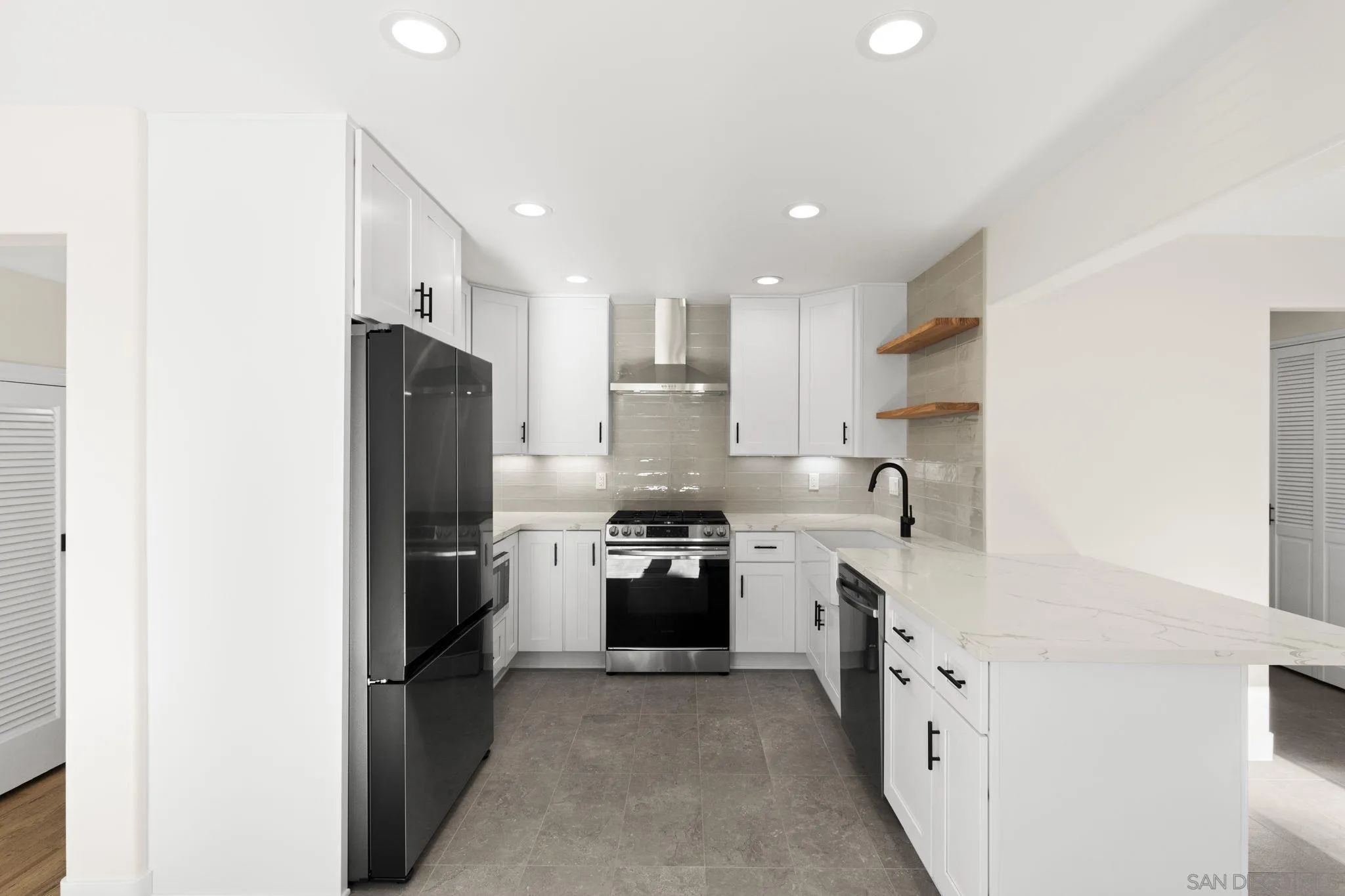 725 Coast S Boulevard La Jolla, CA 92037 - Photo 10 of 23 a kitchen with cabinets and stainless steel appliances
