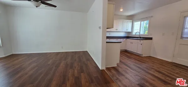 a kitchen with wooden floors and a sink