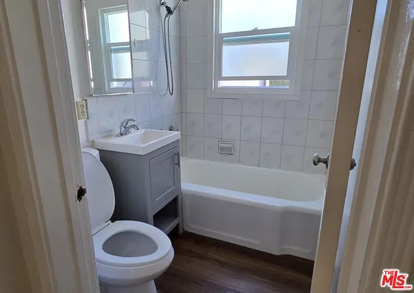 a bathroom with a sink a toilet and bathtub