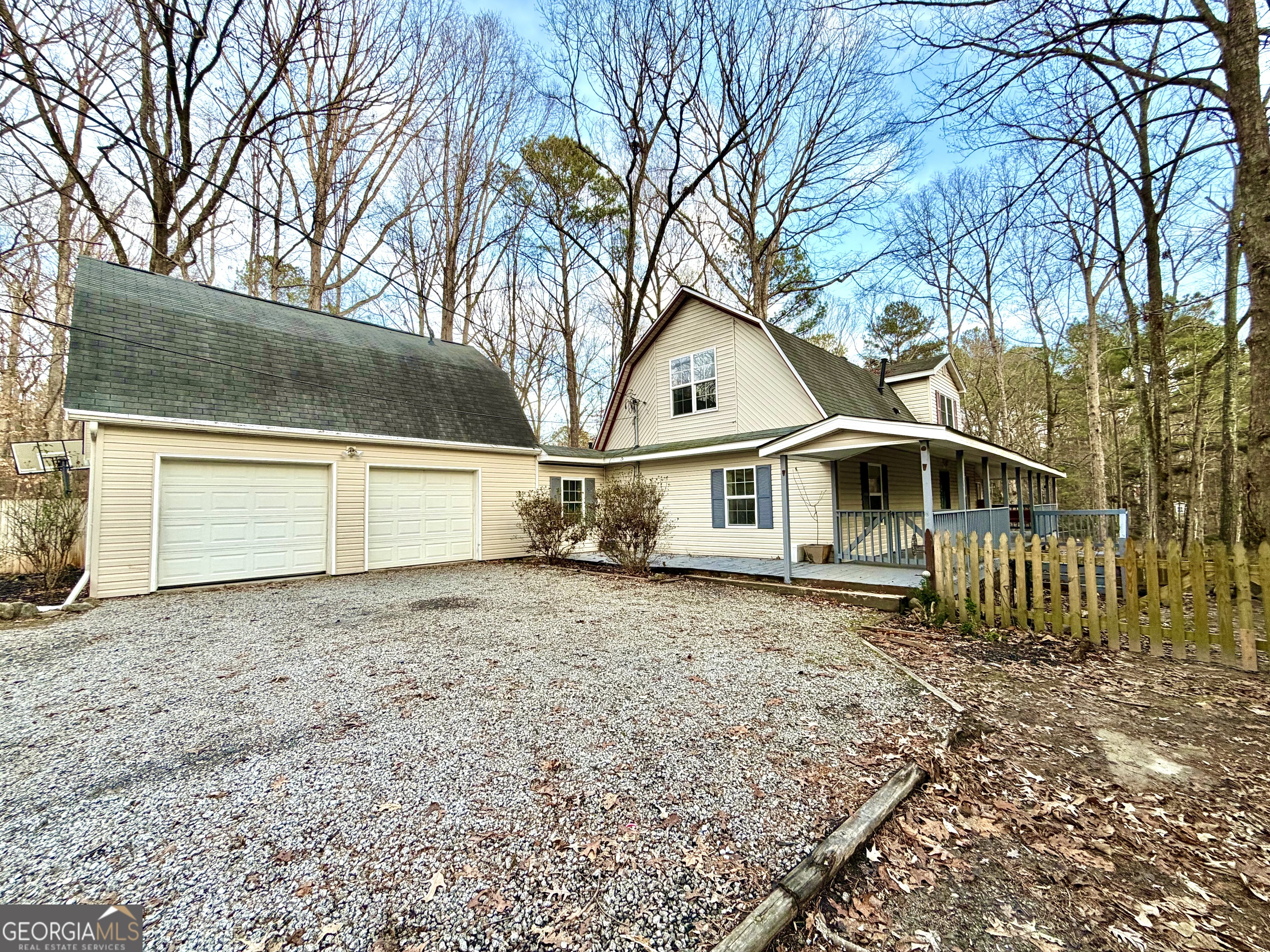 a white house that has a tree in front of it