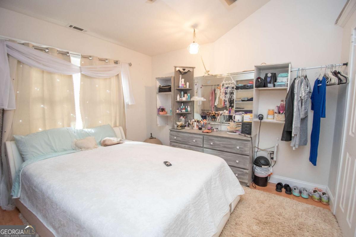 134 Rustica Drive Newnan, GA 30263 - Photo 11 of 32 a bedroom with a bed a large window and walk in closet