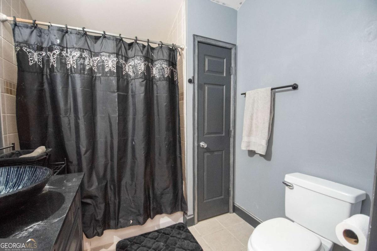 134 Rustica Drive Newnan, GA 30263 - Photo 17 of 32 a bathroom with a toilet a sink and shower