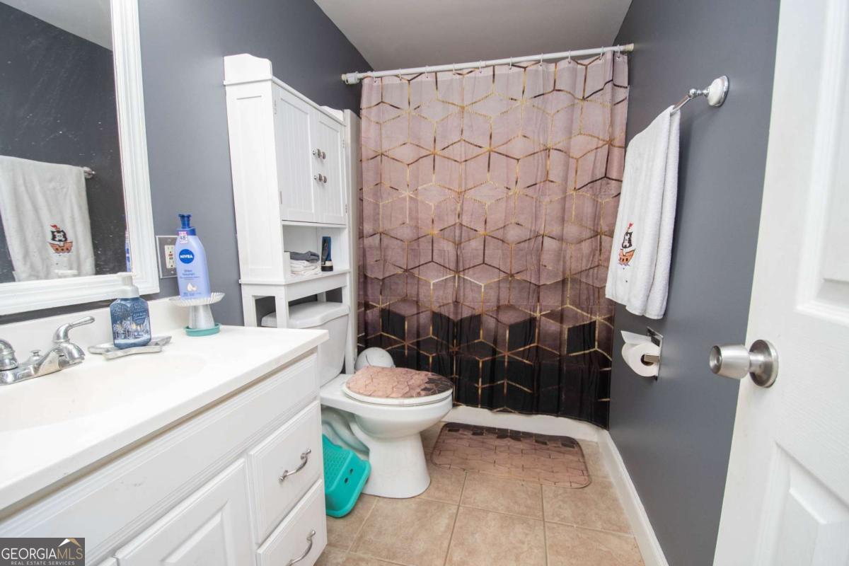 134 Rustica Drive Newnan, GA 30263 - Photo 18 of 32 a bathroom with a sink toilet and shower