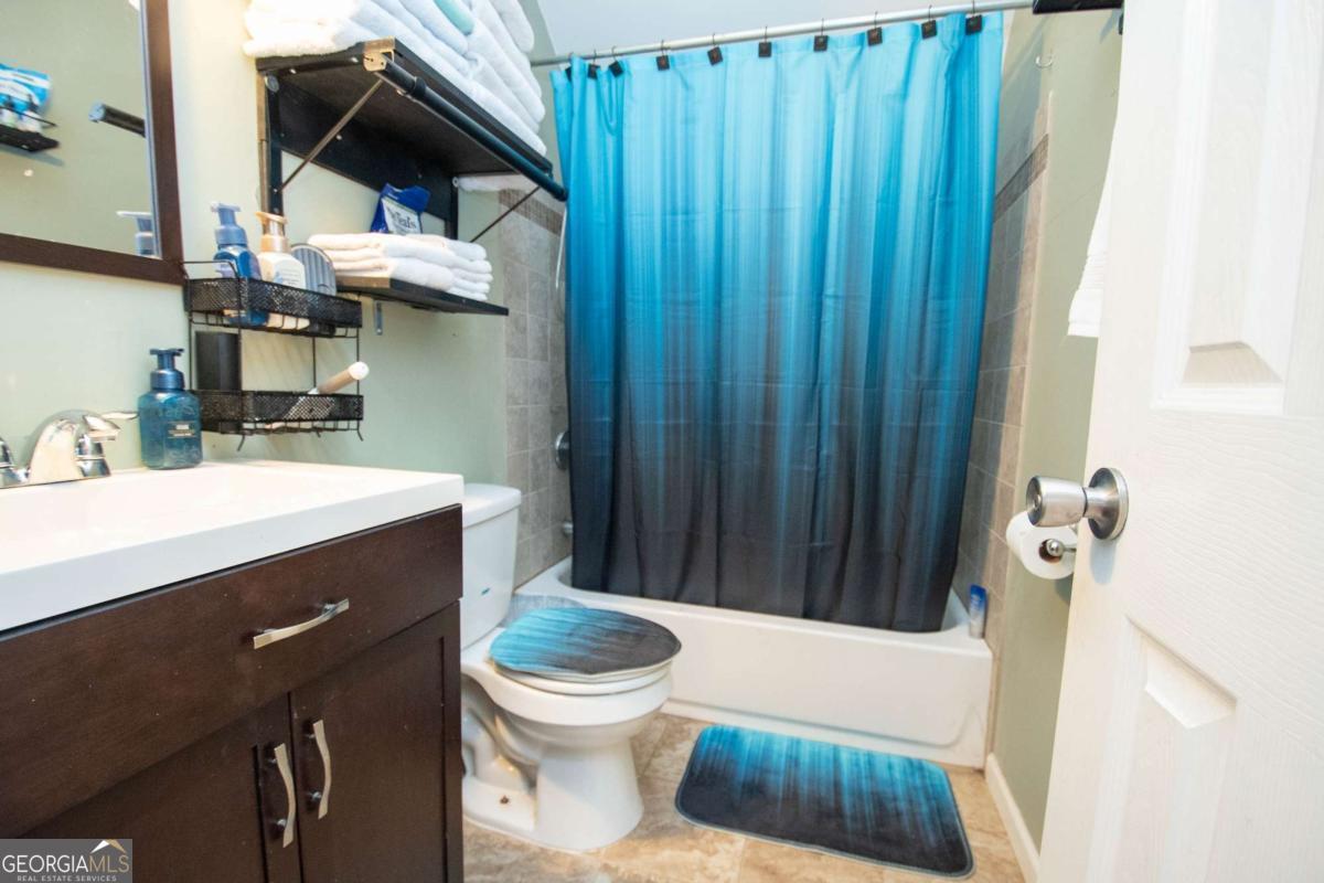 134 Rustica Drive Newnan, GA 30263 - Photo 22 of 32 a bathroom with a sink a toilet and shower