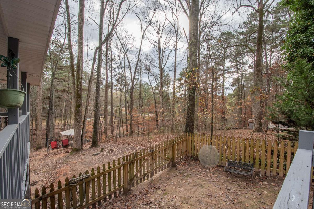 134 Rustica Drive Newnan, GA 30263 - Photo 25 of 32 a view of a pathway with a wooden fence