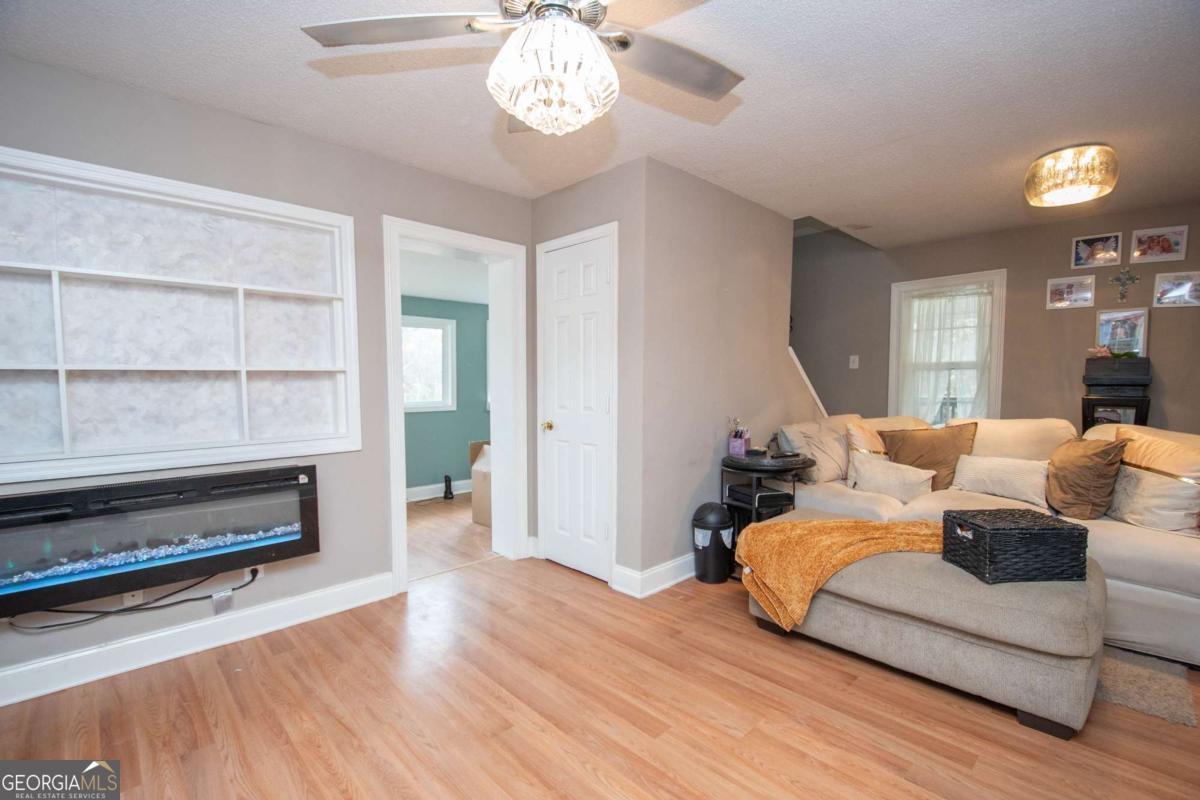 134 Rustica Drive Newnan, GA 30263 - Photo 6 of 32 a living room with furniture a wooden floor and a large window