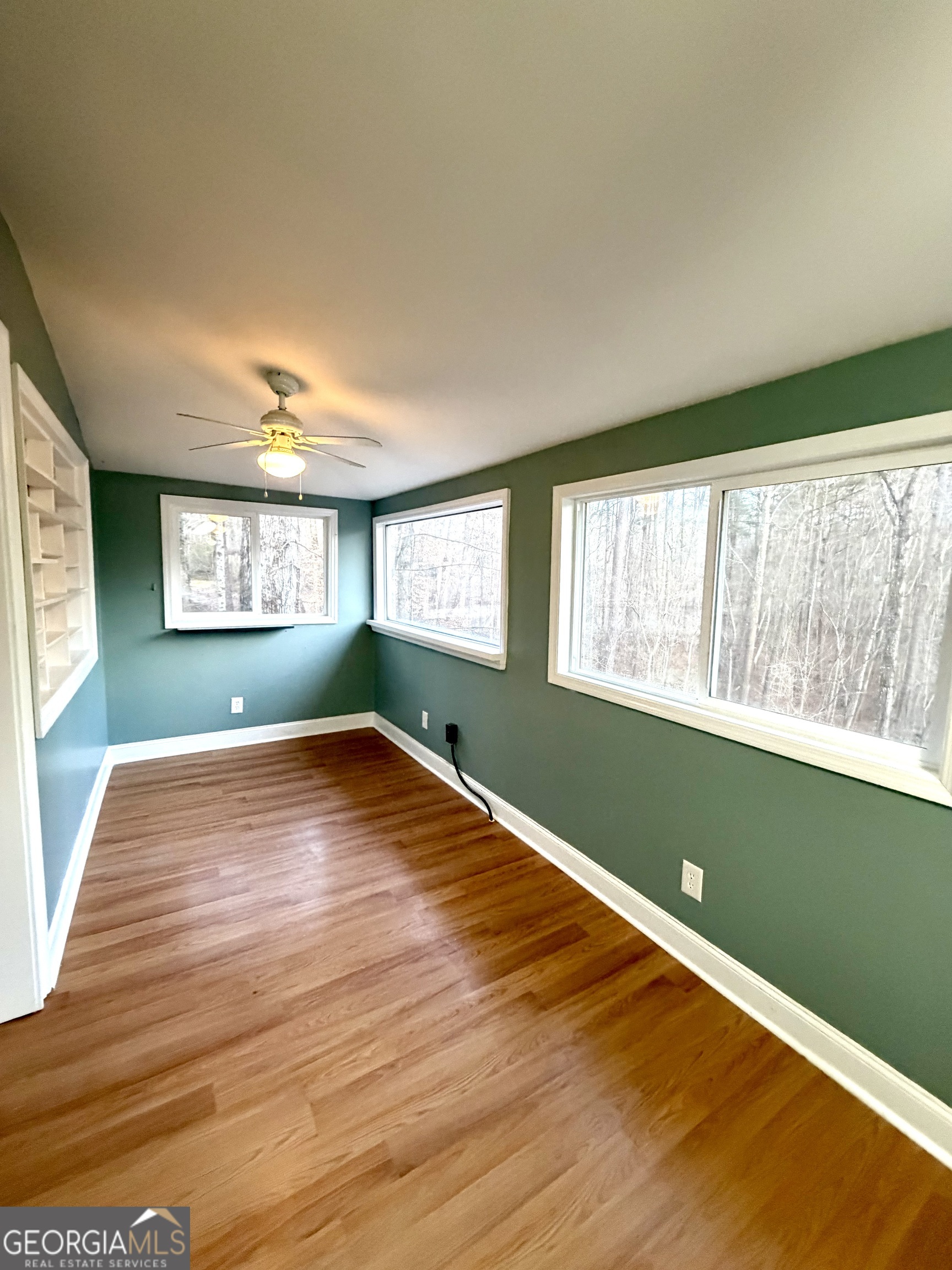 134 Rustica Drive Newnan, GA 30263 - Photo 10 of 32 a view of empty room with window and wooden floor