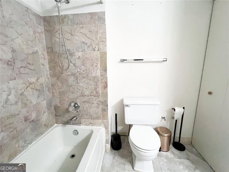 6379 Wedgeview Court Tucker, GA 30084 - Photo 11 of 16 a bathroom with a toilet and a bathtub