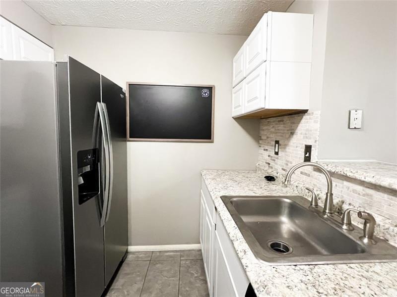 6379 Wedgeview Court Tucker, GA 30084 - Photo 7 of 16 a kitchen with a sink and refrigerator