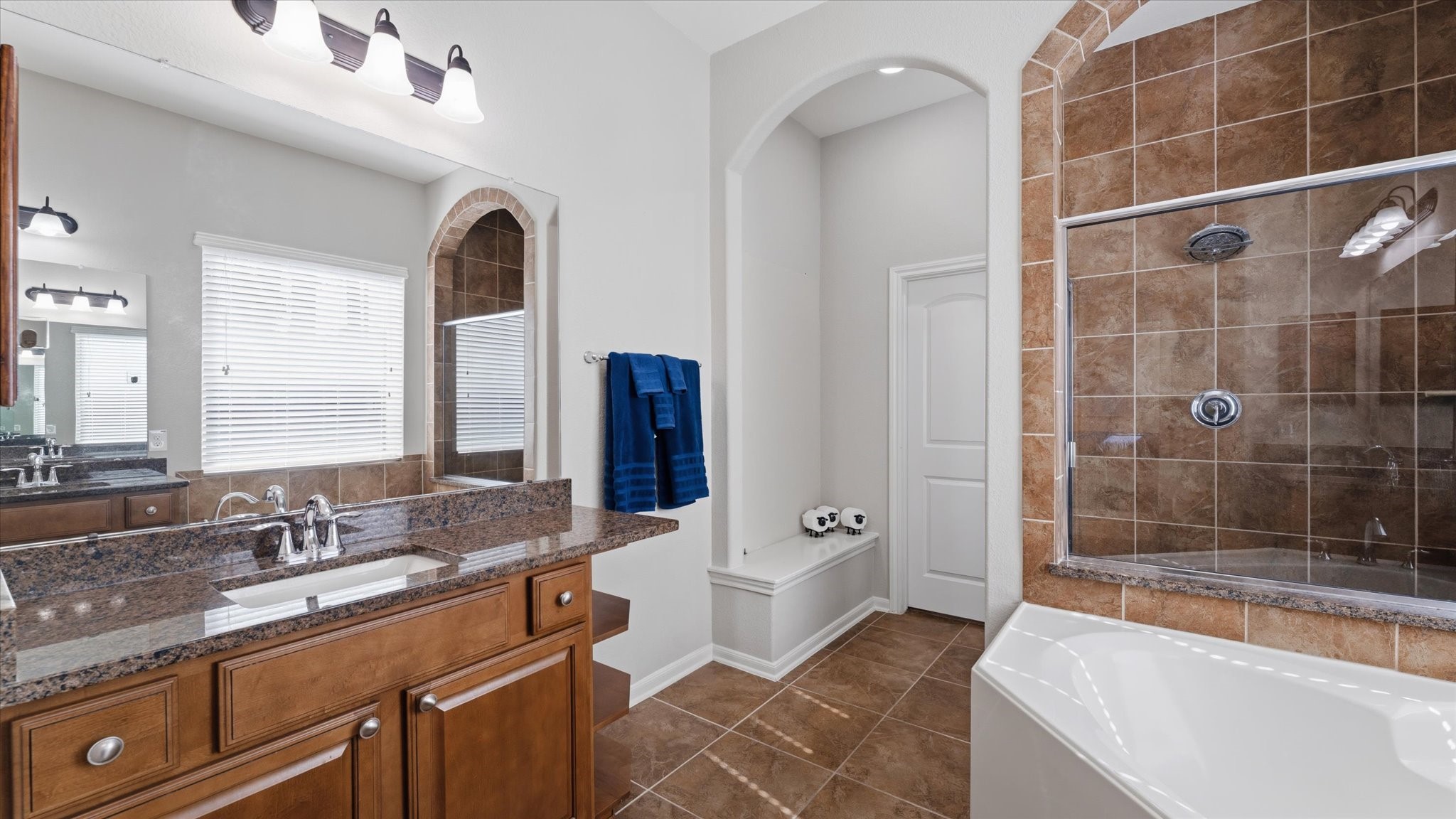14 Painted Post Place Spring, TX 77389 - Photo 23 of 43 a spacious bathroom with a double vanity sink a mirror and a bathtub