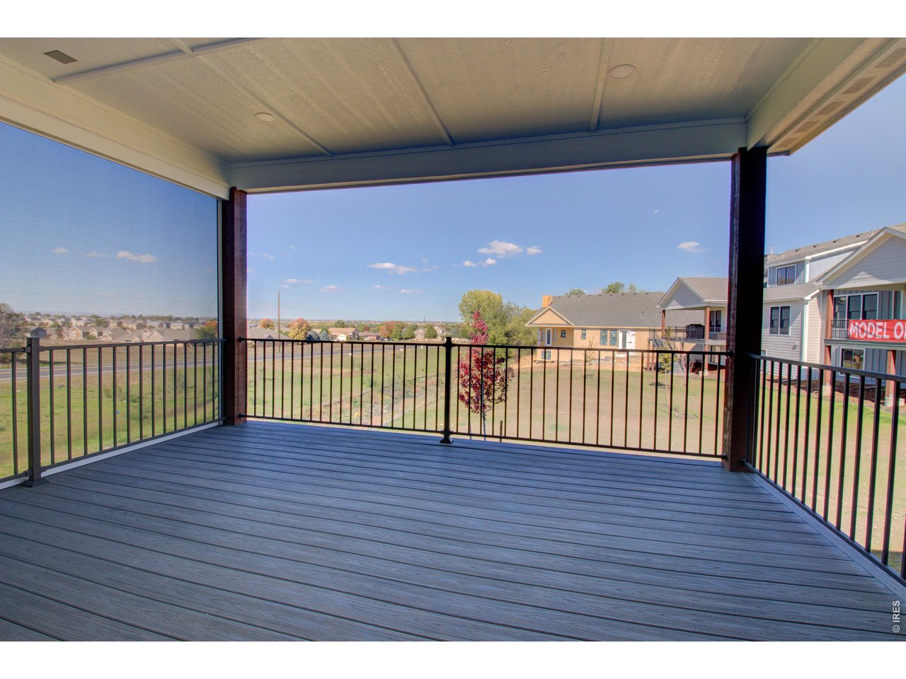 5705 2nd Road Greeley, CO 80634 - Photo 35 of 46 The expansive, covered back Trex deck is accessed from the kitchen. It's equipped with full length automatic sunshades.