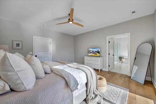 a living room with furniture a flat screen tv and a large window