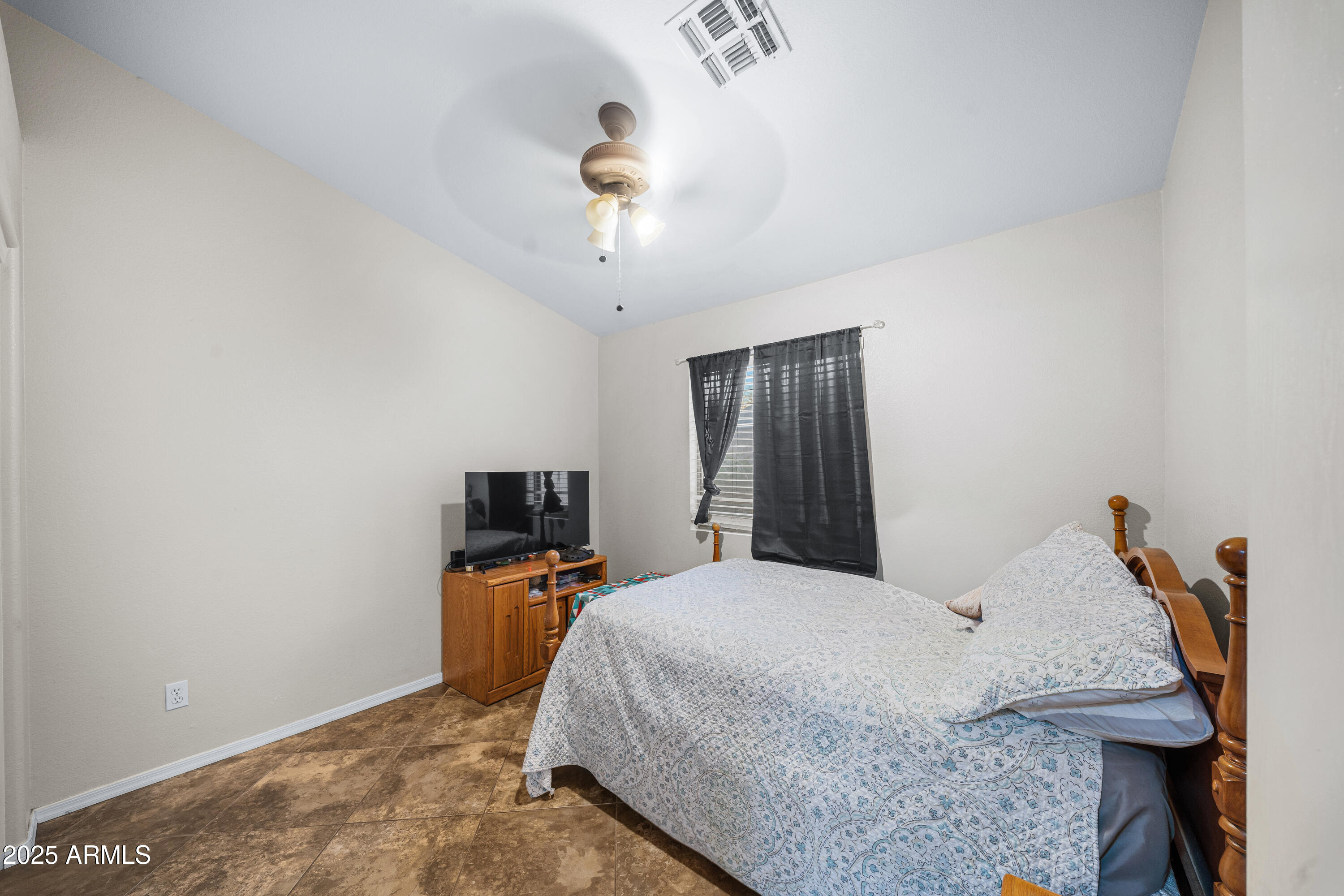 1428 West Mesquite Avenue Apache Junction, AZ 85120 - Photo 13 of 16 a bedroom with a bed and a tv on a table