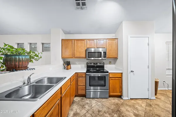a kitchen with stainless steel appliances granite countertop a refrigerator and a sink