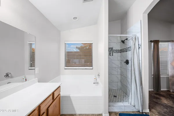 a spacious bathroom with a double vanity sink and a mirror