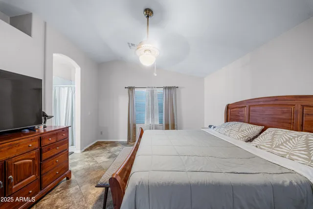 a bedroom with a bed and a tv on a table