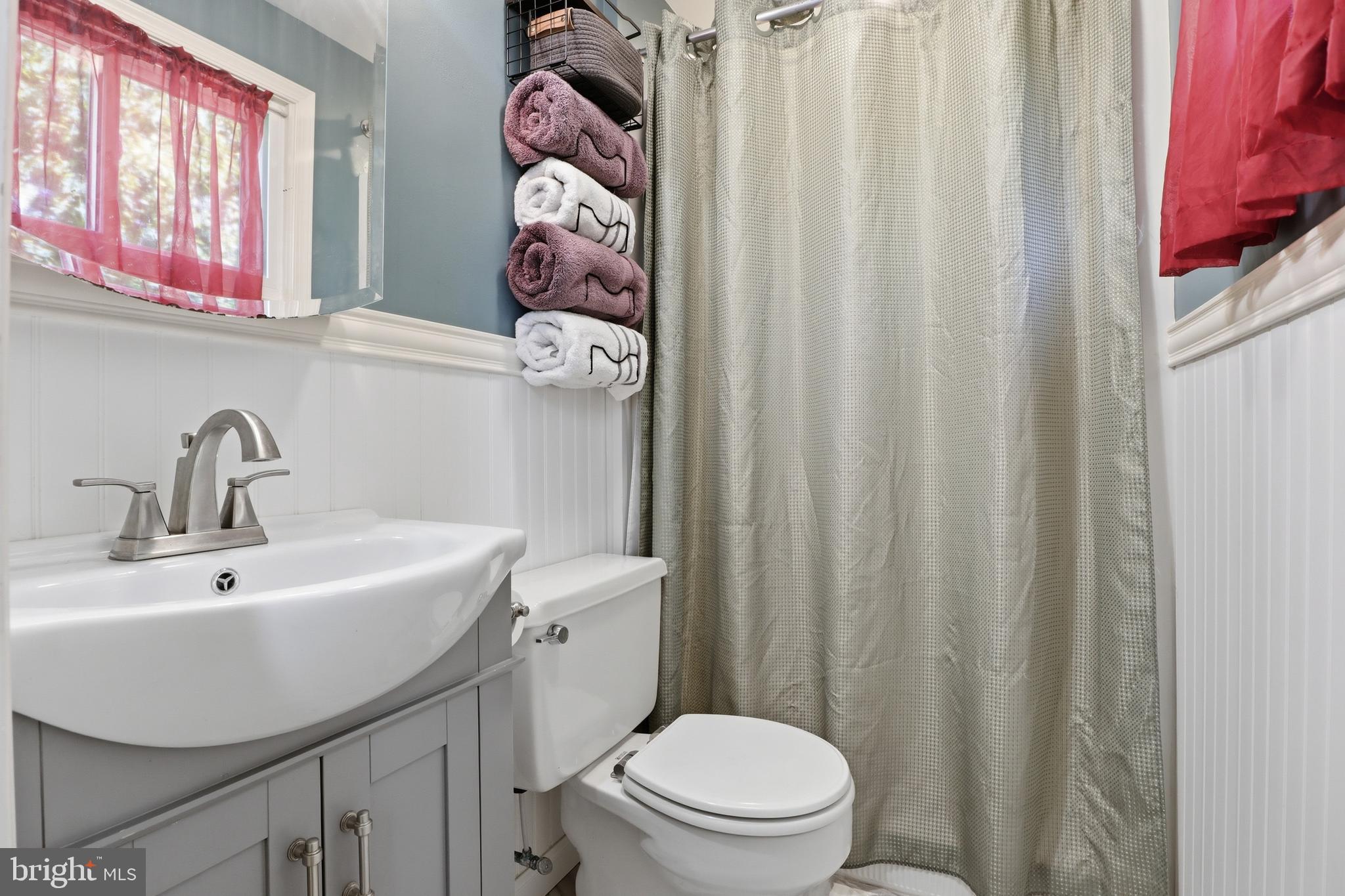 1072 Lambley Road Landisville, PA 17538 - Photo 8 of 46 a bathroom with a sink a toilet and shower curtain