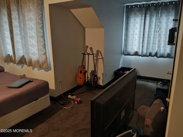 a bedroom with furniture and a window