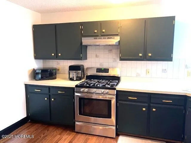 a kitchen with a sink and a stove