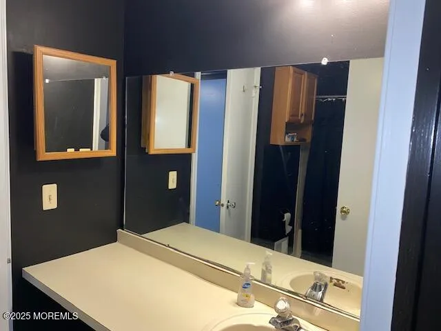 a bedroom with a bed and a mirror