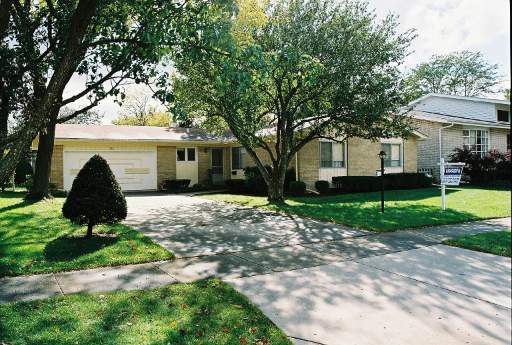 869 North Merrill Street Park Ridge, IL 60068 - Photo 1 of 1 a view of a white house in front of a yard with potted plants and large trees