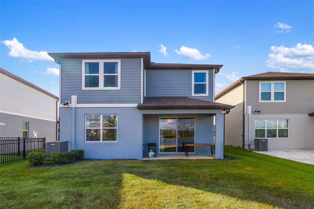 9406 Lamine Way Parrish, FL 34219 - Photo 2 of 74 a view of a brick house with a yard and large trees